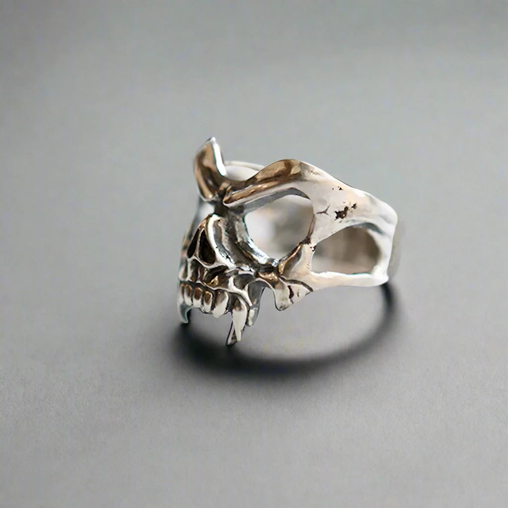 a silver adjustble skull ring