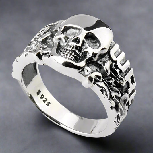 Chunky 925 sterling silver skull ring containing detailed motifs on the ring band