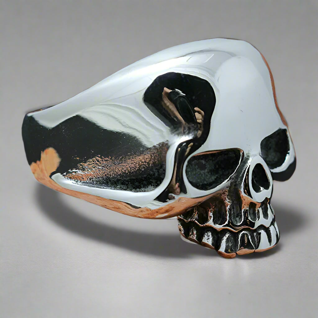 a chunky steel skull ring