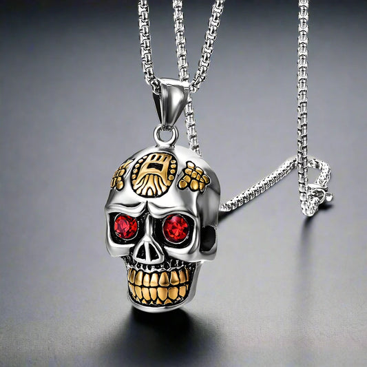 A silver skull pendant necklace containing intricate detail, gold teeth and ruby red eyes